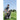 Man organizing golf clubs in a golf course fairway under clear sky