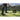 A person prepares to hit a golf ball with a club near a golfbag on a grassy field