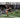 Man runs on turf pulling sled for resistance training in gym with weight equipment