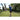 Children with toys swing and throw objects in a yard surrounded by trees and grass