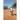 Person practicing baseball on a baseball field with trees in the background