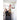 Two boys play basketball indoors near a wallmounted hoop during daytime