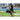 Female athlete carries soccer ball and training equipment on a football field during practice