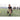 Man performs a workout drill on a sports field during training with a group of players