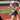 Women hitting yellow softball