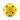A yellow sports ball with multiple black ventilation holes on a white background