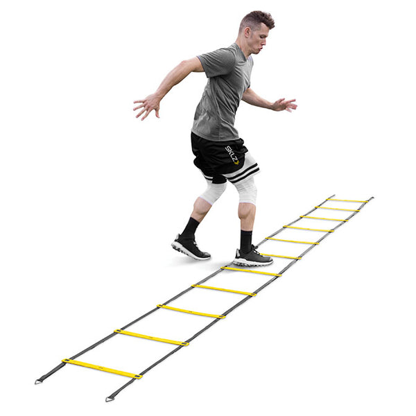 Man practicing on a quick ladder in a white background