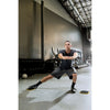Man using training slides in gym for lunges