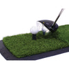Close up view of golf hitting matt with golf club behind golf ball on tee