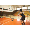 Woman practicing basketball with SKLZ's  solo assist sports net