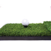 Front view of golf ball and tee sitting on top of practice golf mat